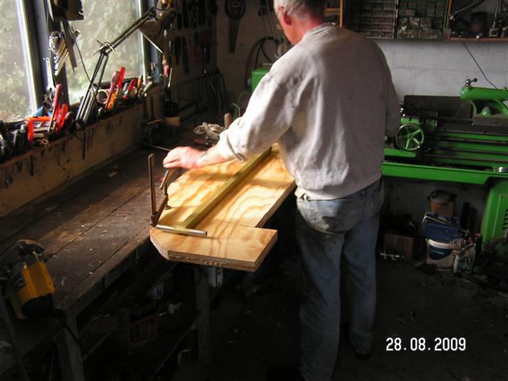 Renovering af Hæk - 28 august
Den gamle hæk træ plade var kun 32cm tyk så her er Troldmanden igang med at fræse et spor i den nye hæk så den kan kommme ned hvor den gamle sad, der sgu fedt at se ham finde løsninger på disse ting som forlængst ville have fået  mig til at løbe skrigende bort og oppgive billede 13