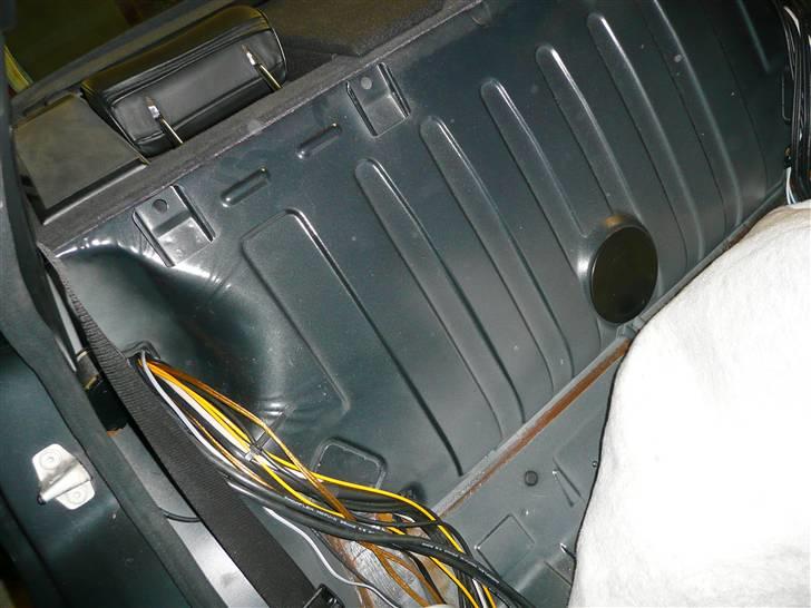 BRABUS W124 Ground Zero installation Stealth - Her har jeg fået taget lyddæmpnings tæppet af og så kommer kabel førings kanalerne til syne.
Der er 2 kabelførings huller et i hver side.
Som det ses her har jeg lige trukket højttaler kablerne frem til de foreste enhedder i bilen.
De blev desværre installeret i samme side som power kablerne, men det har ikke haft den fjerneste ulæmpe og grunden til det kommer på nogle af de efterfølgende billeder. billede 25