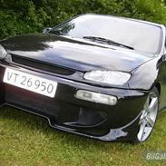 Mazda 323 c (regnbuen) solgt