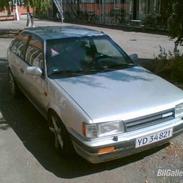 Mazda 323 1,6 gt/x 2talt skadet